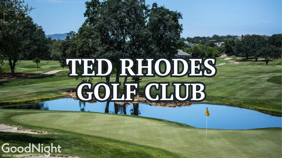 A scenic view over a beautiful golf course featuring a water feature, a prominent golf flag, and open green spaces ideal for playing and relaxing. The scene is tranquil yet social, with the clubhouse visible in the background, hinting at post-game gatherings.