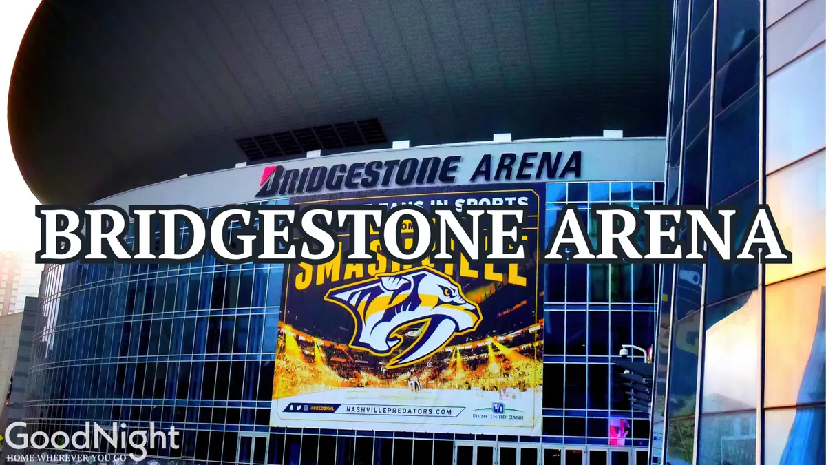 The Bridgestone Arena, home of the Nashville Predators, with a prominent banner and large glass windows. The scene is lively and modern, highlighting a key sports and concert venue steps away from downtown action.