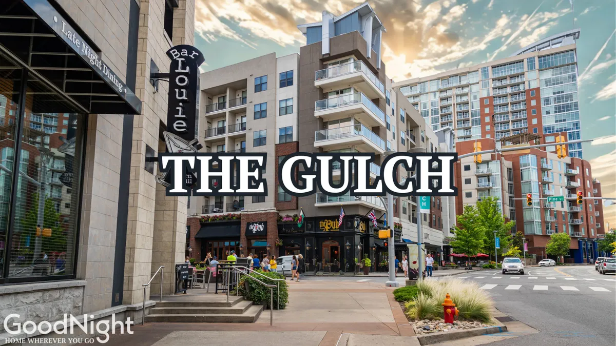 An urban exterior scene featuring Bar Louie with modern apartments and a bustling sidewalk café. The lively atmosphere highlights options for dining, socializing, and after-work gatherings, with people enjoying the vibrant streetscape.